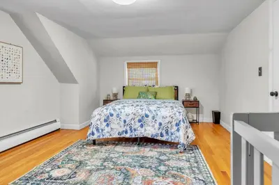 a bedroom with a bed and a rug at 4 Bedroom House Near Bristol Center in Bristol