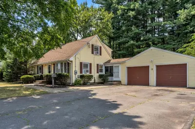 a yellow house with a garage at 4 Bedroom House Near Bristol Center in Bristol