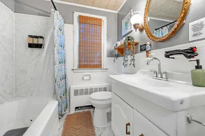 a bathroom with a sink toilet and a mirror at 4 Bedroom House Near Bristol Center in Bristol