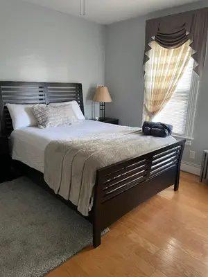 a bedroom with a large bed and a window at PRIVATE ROOM IN SHARED 3 BED - 1 BATH home in Hartford