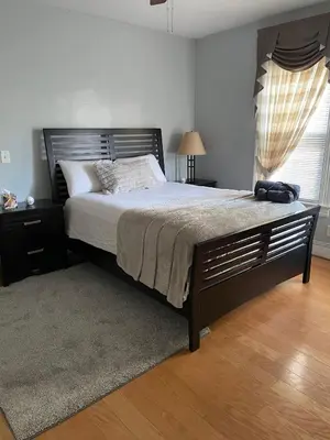 a bedroom with a large bed and a window at PRIVATE ROOM IN SHARED 3 BED - 1 BATH home in Hartford