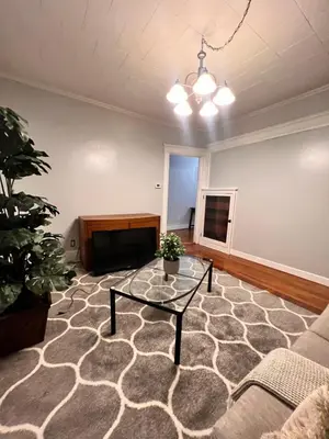 a living room with a table and a couch at PRIVATE ROOM IN SHARED 3 BED - 1 BATH home in Hartford
