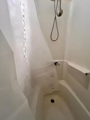 a bathroom with white walls and a white stairs at PRIVATE ROOM IN SHARED 3 BED - 1 BATH home in Hartford