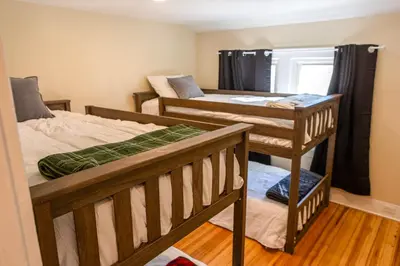 a room with two bunk beds and a stairwell at Ann Inn - Downtown New Milford Apartment in New Milford