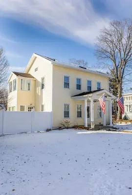 a white house with two american flags in front of it at Ann Inn - Downtown New Milford Apartment in New Milford