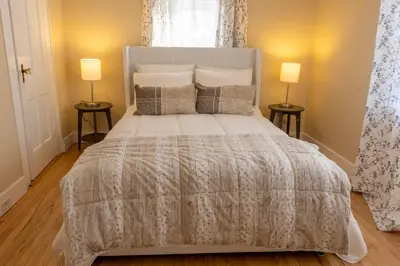 a bedroom with a large bed with two lamps at Ann Inn - Downtown New Milford Apartment in New Milford