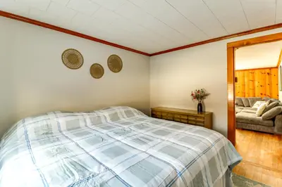 a bedroom with a bed and a couch at Year-Round Fun on Lake Sheridan! Home with Patio