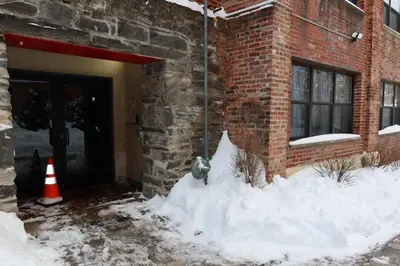 a pile of snow next to a brick building at Chic 2BR Retreat in Albany Cozy, Stylish & Central in Albany