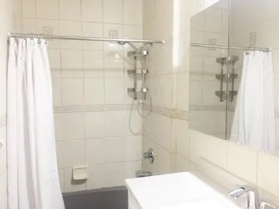 a bathroom with a shower curtain and a sink at 2-Joint Large Deluxe Rooms in Private House - NYC in Sunnyside