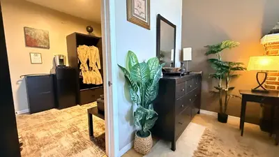 a hallway with a dresser and a plant in a room at 2-Joint Large Deluxe Rooms in Private House - NYC in Sunnyside