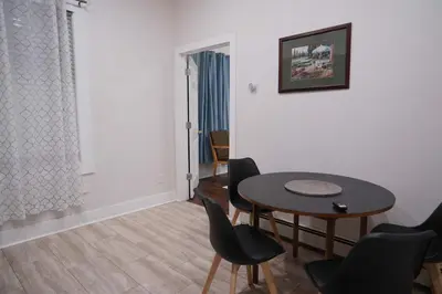 a dining room with a table and chairs in a room at Stylish & Comfortable City Stay in West New York