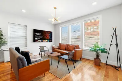 a living room with a couch and a table at Premier 3BR-5BD-3Bath Retreat with NYC Access in Jersey City