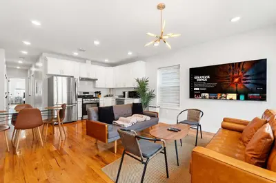 a living room with a couch and a table at Premier 3BR-5BD-3Bath Retreat with NYC Access in Jersey City