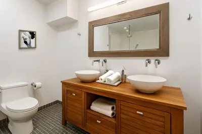 a bathroom with two sinks and a toilet at Drift Haus 4 and half BR Mountain Lodge in Windham