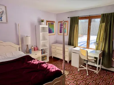 a bedroom with a bed and a desk and a window at Spacious 4BR Near Beaches WFH Office & Pool in Guilford