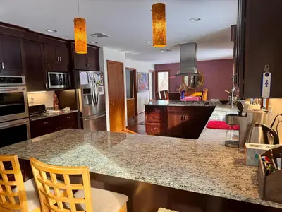 a kitchen with a large counter top in a room at Spacious 4BR Near Beaches WFH Office & Pool in Guilford