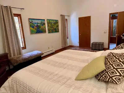 a bedroom with two beds and a chair at Spacious 4BR Near Beaches WFH Office & Pool in Guilford