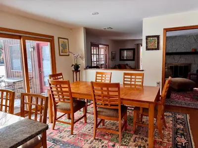 a dining room with a wooden table and chairs at Spacious 4BR Near Beaches WFH Office & Pool in Guilford