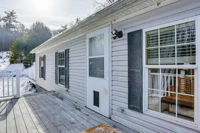 a white house with a porch and a door at Hike and Explore! Nature-Centric Hudson Valley Home in Napanoch