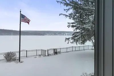 a view of a snow covered yard with an american flag at Candlewood Isle in New Fairfield