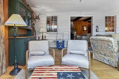 a living room with two chairs and a table at Candlewood Isle in New Fairfield