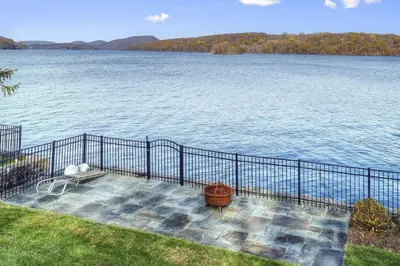 a view of a large body of water with a fence at Candlewood Isle in New Fairfield