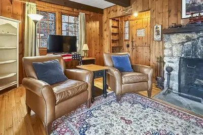 a living room with two chairs and a fireplace at Candlewood Isle in New Fairfield
