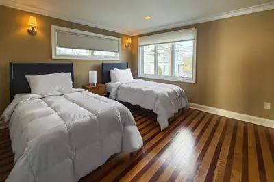 a bedroom with two beds and a window at Pine Creek Beach House in Fairfield