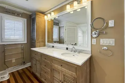 a bathroom with a sink and a large mirror at Pine Creek Beach House in Fairfield