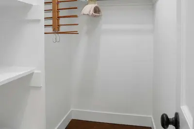 a bathroom with white walls and a wooden rack on the wall at Harbor Haven, Apt #2, 2 BR/1BA in Stamford