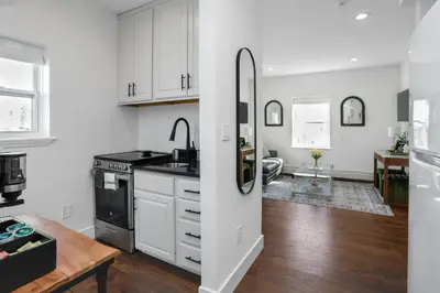 a kitchen with white cabinets and a black counter top at Harbor Haven, Apt #2, 2 BR/1BA in Stamford
