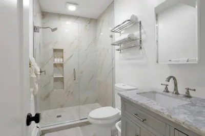 a bathroom with a shower and a toilet and a sink at Harbor Haven, Apt # 3, 3BR/2BA in Stamford