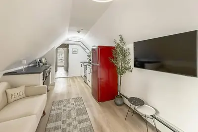 a living room with a red refrigerator and a couch at Harbor Haven, Apt #4 - 2BR/1BA in Stamford
