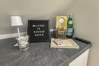 a welcome to harpoon brewery sign and a bottle of wine at Harbor Haven, Apt #4 - 2BR/1BA in Stamford