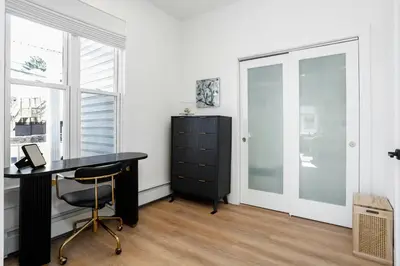 a office with a black desk and a cabinet at Harbor Haven, Apt #5, 3BR/2BA in Stamford