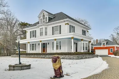 a large white house with a dog standing in the snow at Dedicated Workspace! Home 2 Mi to Dtwn Schenectady in Schenectady