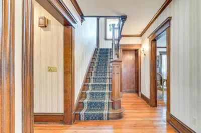 a hallway with a staircase in a house at Dedicated Workspace! Home 2 Mi to Dtwn Schenectady in Schenectady