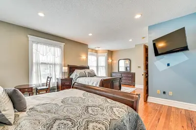 a bedroom with two beds and a flat screen tv at Dedicated Workspace! Home 2 Mi to Dtwn Schenectady in Schenectady
