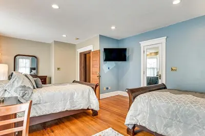 two beds in a room with blue walls at Dedicated Workspace! Home 2 Mi to Dtwn Schenectady in Schenectady