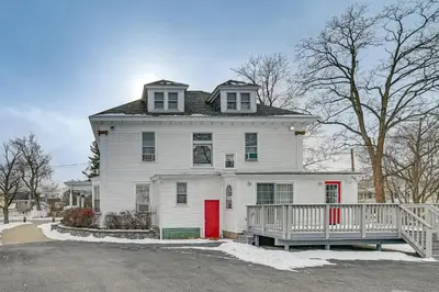 a white house with a red door at Dedicated Workspace! Home 2 Mi to Dtwn Schenectady in Schenectady