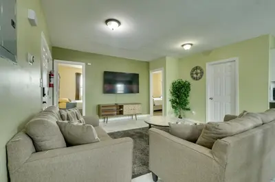a living room with two couches and a tv at Explore NYC, Parks and Beaches! Top-Floor Apt in Mount Vernon