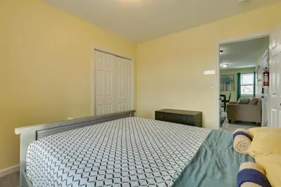 a bedroom with a bed and a door to a room at Explore NYC, Parks and Beaches! Top-Floor Apt in Mount Vernon