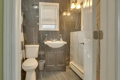 a bathroom with a toilet and a sink at Explore NYC, Parks and Beaches! Top-Floor Apt in Mount Vernon