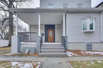 a house with a brown door and a porch at Explore NYC, Parks and Beaches! Top-Floor Apt in Mount Vernon