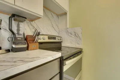 a kitchen with a stove and a counter top at Easy NYC Access Updated Apt Near Parks and Bay! in Mount Vernon