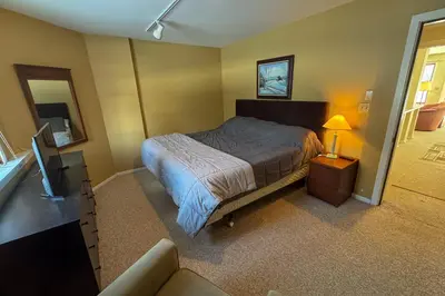 a bedroom with a bed and a tv and a couch at Glen Run 2S in West Dover