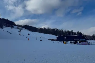 a snow covered ski slope with a ski lift at Glen Run 2S in West Dover