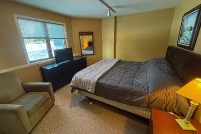 a bedroom with a bed and a couch and a chair at Glen Run 2S in West Dover