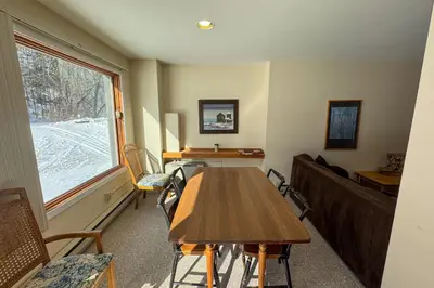 a living room with a table and a couch at Glen Run 2S in West Dover