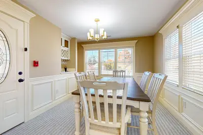 a dining room with a wooden table and chairs at Centrally Located Home by Holyoke Medical Center in Holyoke